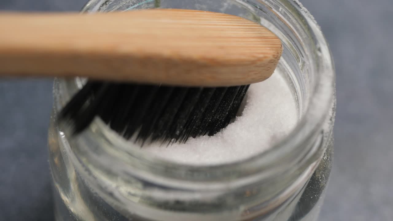 Cleaning a jar with a brush and salt