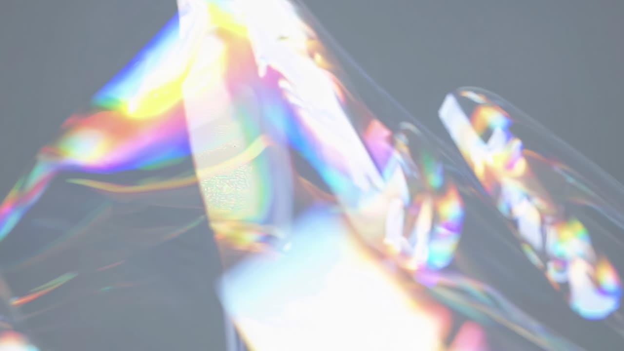 Abstract video concept with a close-up angle capturing colorful light refractions on a reflective