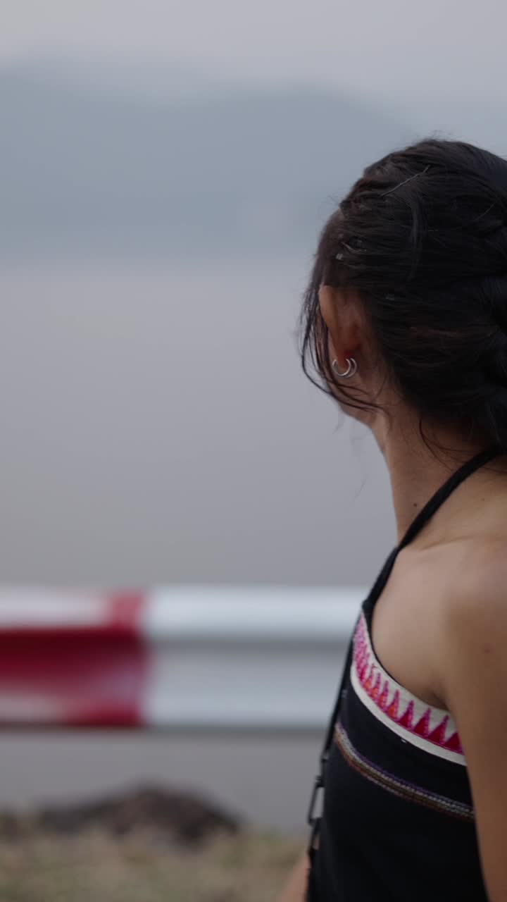 Portrait of a woman with ethnic clothing by a lake