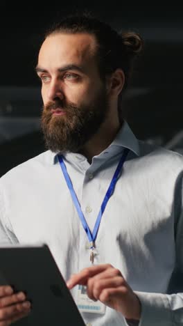 vertical video server room technician next to coworkers reviewing ai llm visualization