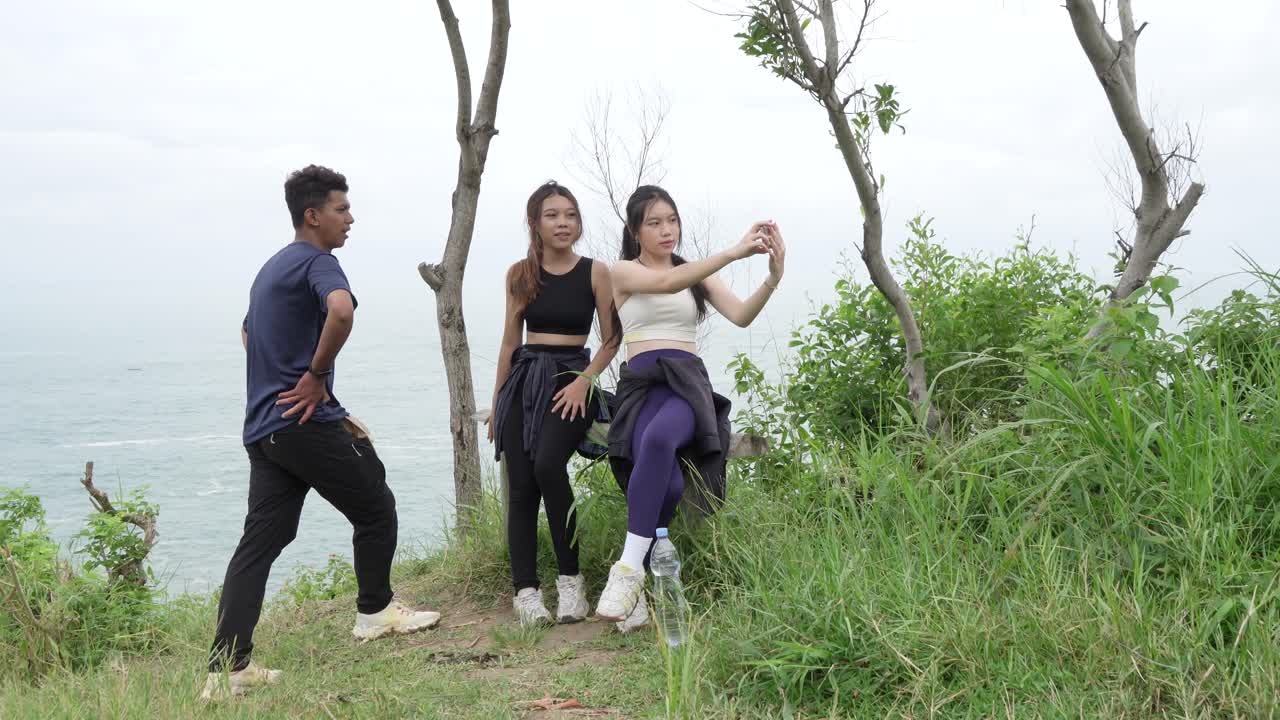 Friends Taking a Selfie on a Hiking Trip by the Ocean