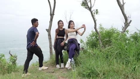 friends taking a selfie on a hiking trip by the ocean
