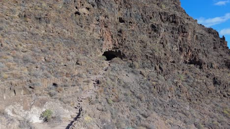 flying towards the cave and entrance to the ansite fortress on the island of gran canaria