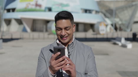 Happy-middle-eastern-man-having-video-call-through-smartphone