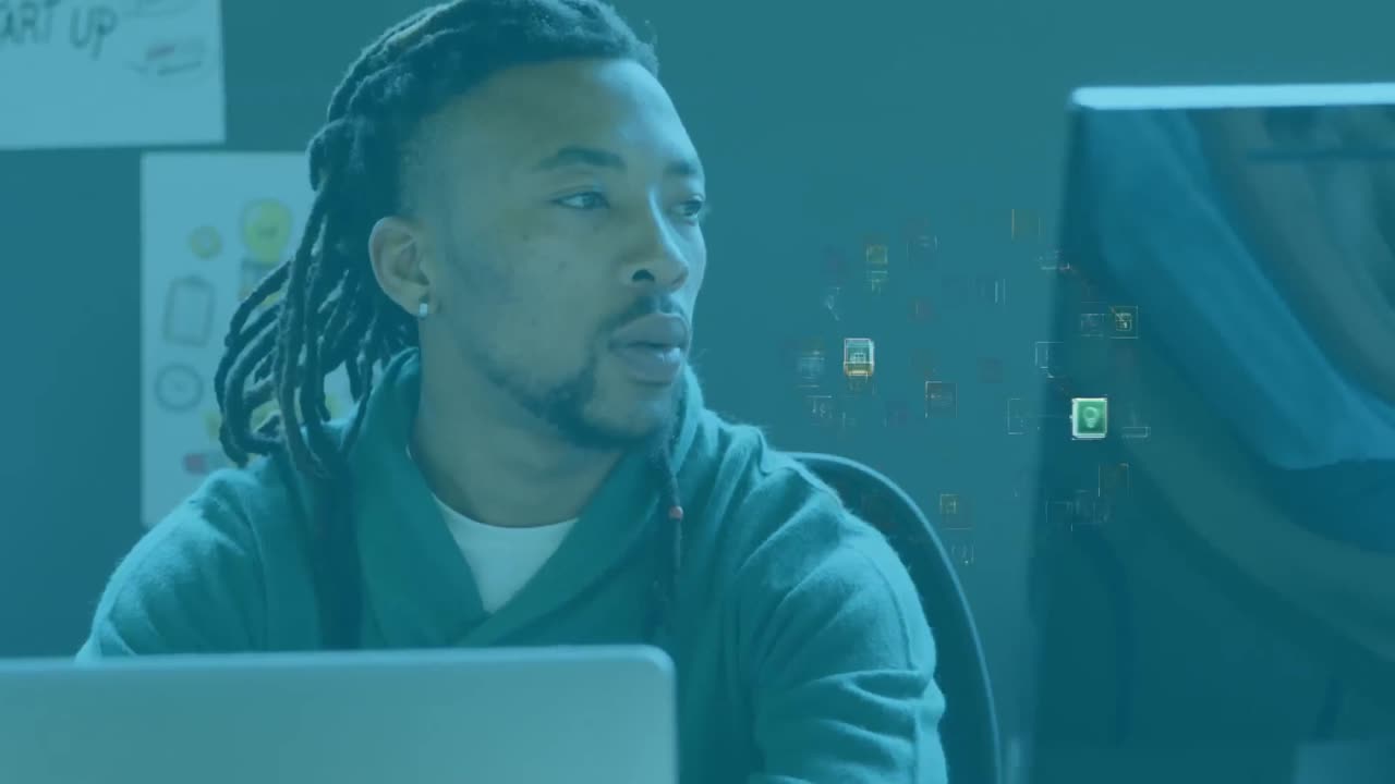 Animation of network of connections and media icons over businessman at desk using computer