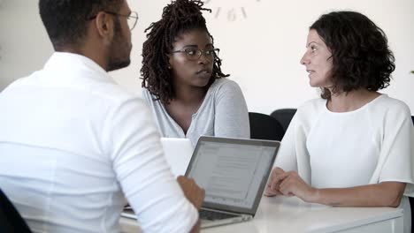 back view of business consultant listening clients at office