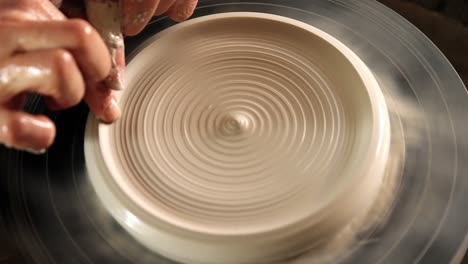 male potter making pot