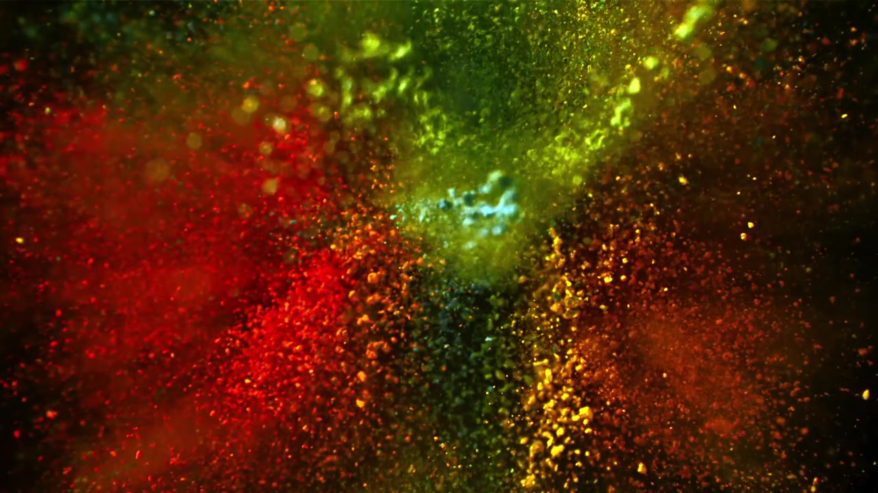 Esplosione di polvere colorata vibrante al rallentatore su sfondo nero