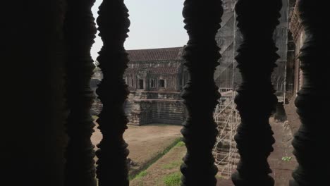 dolly through window with balusters at the angkor wat temple in cambodia. 4k