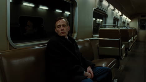 man sitting on a subway train