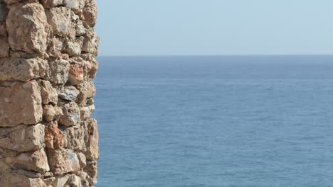 stones in a wallstone with the sea at background