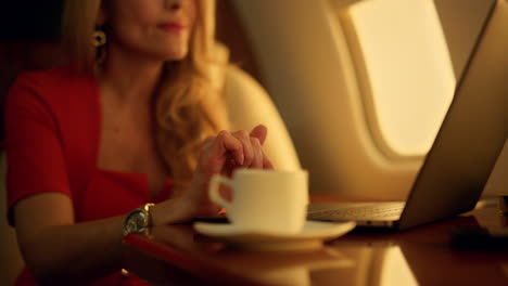 Beautiful-banker-working-computer-on-corporate-trip.-Hands-touching-pad-closeup.