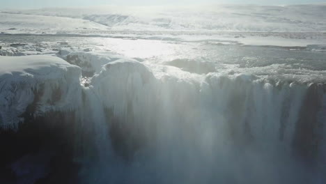 beautiful drone shot of frozen waterfall in iceland