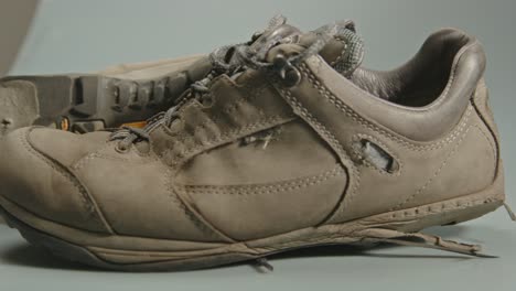 Dolly-of-pair-of-worn-and-torn-hiking-shoes