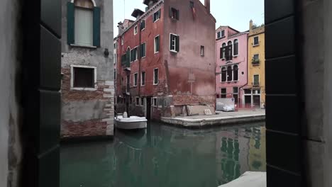 Window-view-of-Venice-Italy,-water-canal-and-houses-over-water,-non-touristic