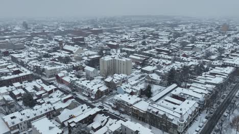 Drone-flight-over-snowy-city-with-houses-and-blocks-in-american-town