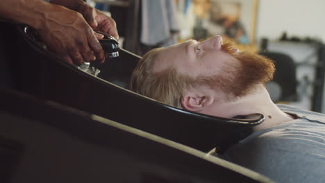 Man-Getting-Hair-Wash-in-Barbershop