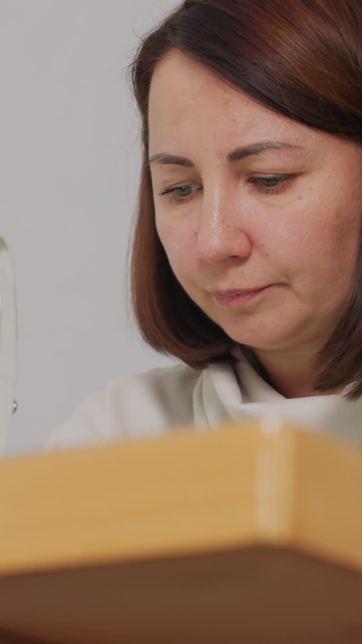 Tailor working meticulously on fabric, Craftswoman precisely guiding textile through professional equipment, Detailoriented female tailor carefully handling fabric in modern artisanal studio