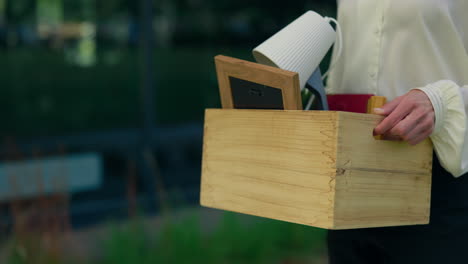 woman leaving with a box of personal items