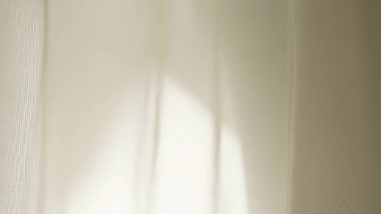 Curtains no visible action, in indoor setting with natural light, with curtains, from a static shot from a consistent angle perspective, with beige, white accents, and neutral calm mood.