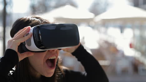 Close-up-shot-of-young-dark-haired-woman-in-warm-black-waistcoat-putting-on-virtual-reality-glasses