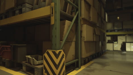 warehouse storage area with boxes and pallets during evening hours