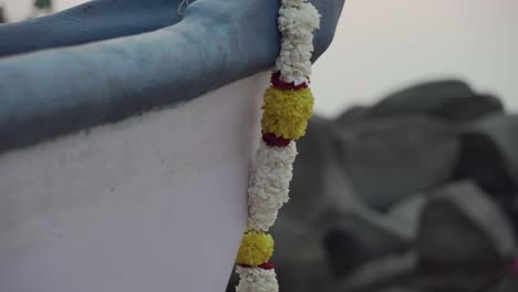 panning-up-shot-across-boat-with-floral-garland-hanging-from-the-bow