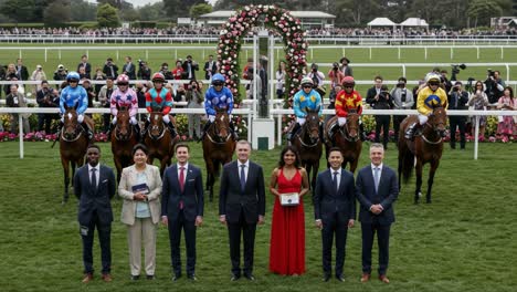 celebrating victory: a stunning gathering of jockeys and supporters in elegant attire at the prestigious racing event surrounded by colorful decorations and enthusiastic crowd