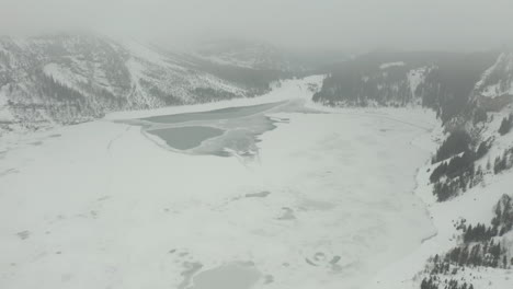 tilt up over vast frozen lake in the wilderness