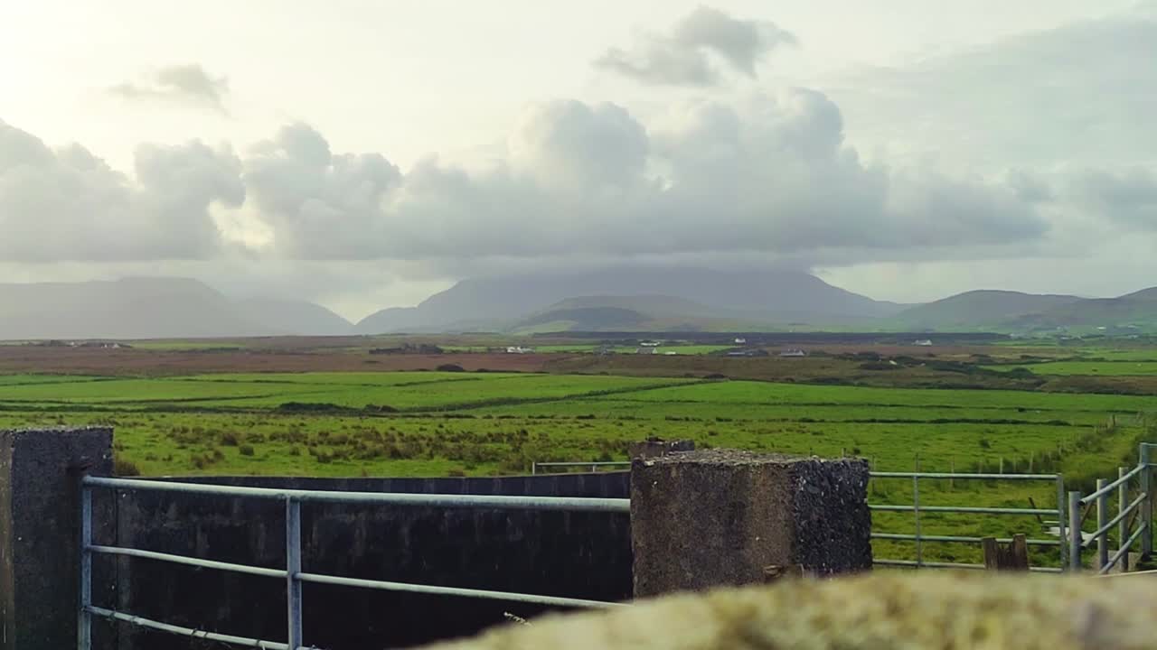 White Cloud Time lapse over the Farm Field with mountains around