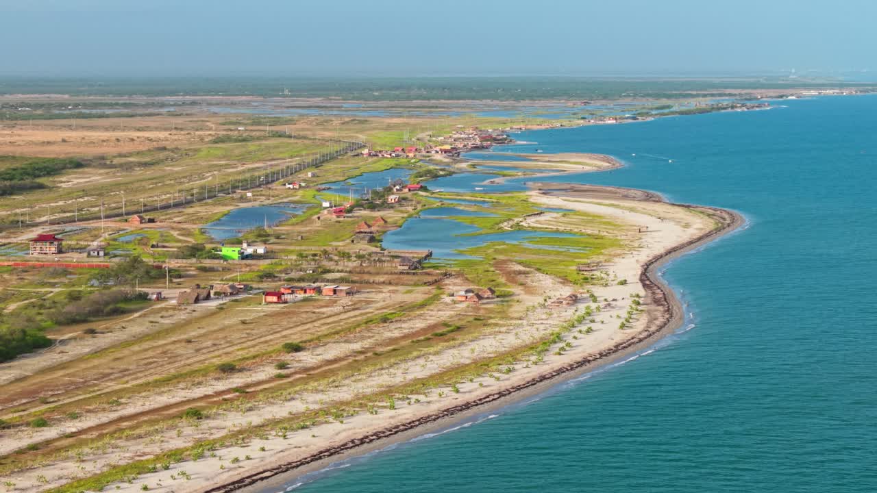 Expansive and panoramic aerial tilt-down drone footage showing the beautiful coastline and village of mayapo in colombia