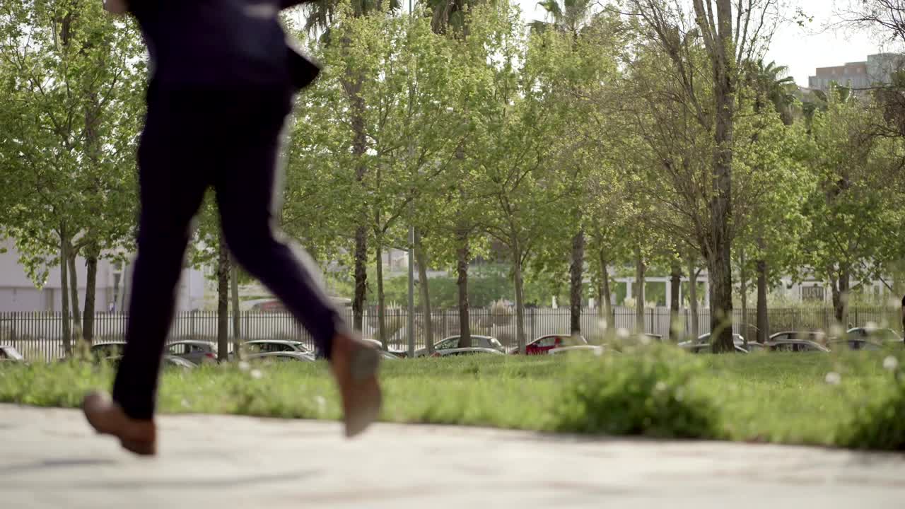 Low section of businessman running on stairs outdoor