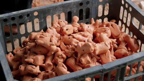 Fired-intricate-clay-figurines-placed-into-container-after-being-fired-in-Than-Ha-Hoi-An-Vietnam