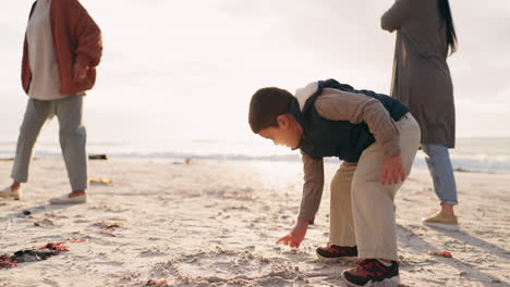 boy, family and drawing in sand