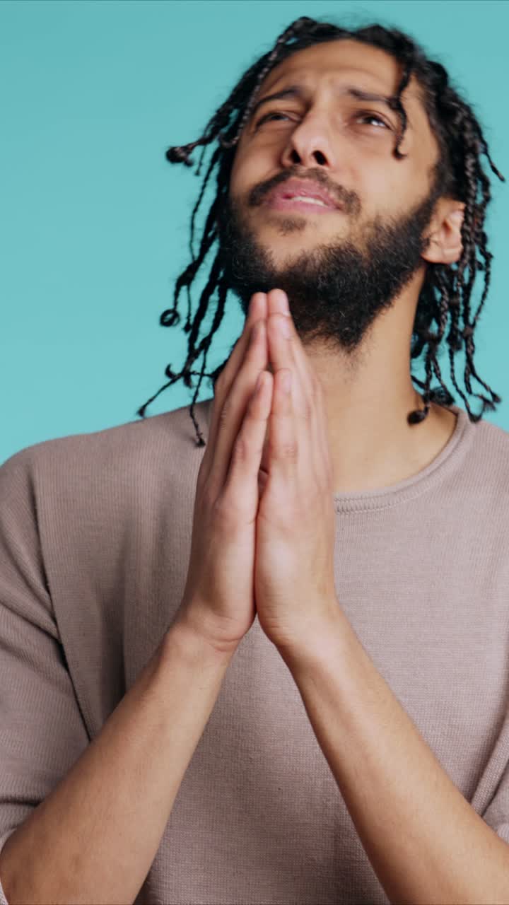 Vertical video Pious man praying to his god, asking for forgiveness, feeling desperate, studio