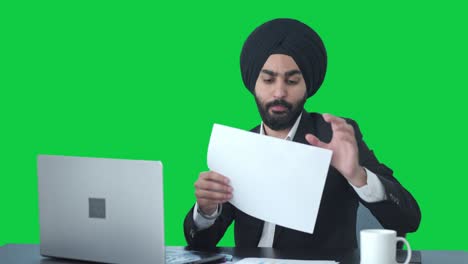 sikh indian businessman working on laptop green screen