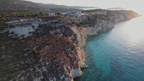 clifftop view of a serene coastal landscape at sunset in greece