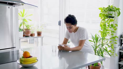 happy woman using mobile phone while having breakfast 4k