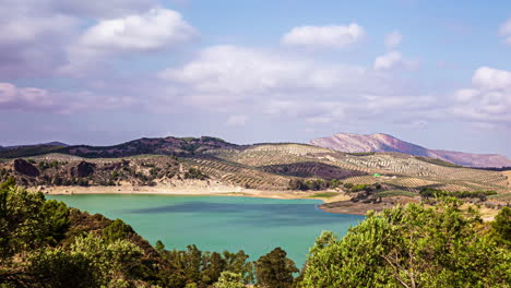 blue lake water and majestic landscape with flowing clouds, time lapse