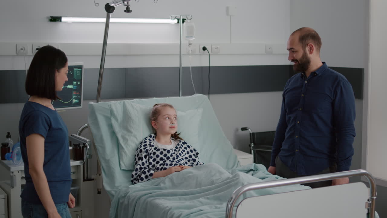 Cheerful positivity family sharing high five with liitle daughter patient during recovery examination