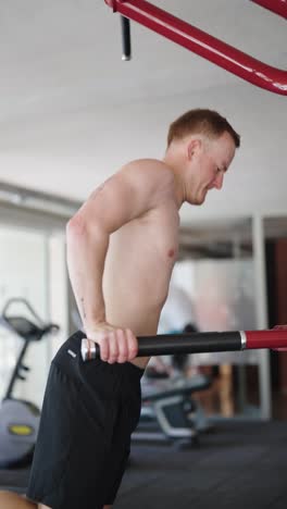 Vertical-view-of-caucasian-male-do-dip-exercise-on-horizontal-bar