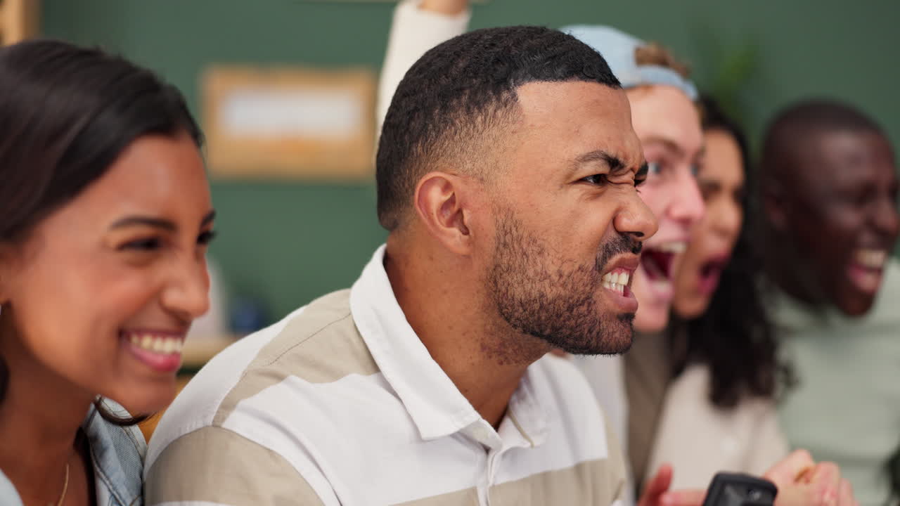 Group of diverse friends watching a sports game and celebrating