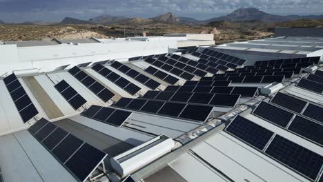 Drone-shot-of-solar-panels-on-roof-of-large-industrial-building