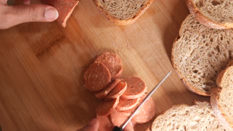 preparing a sausage and bread sandwich