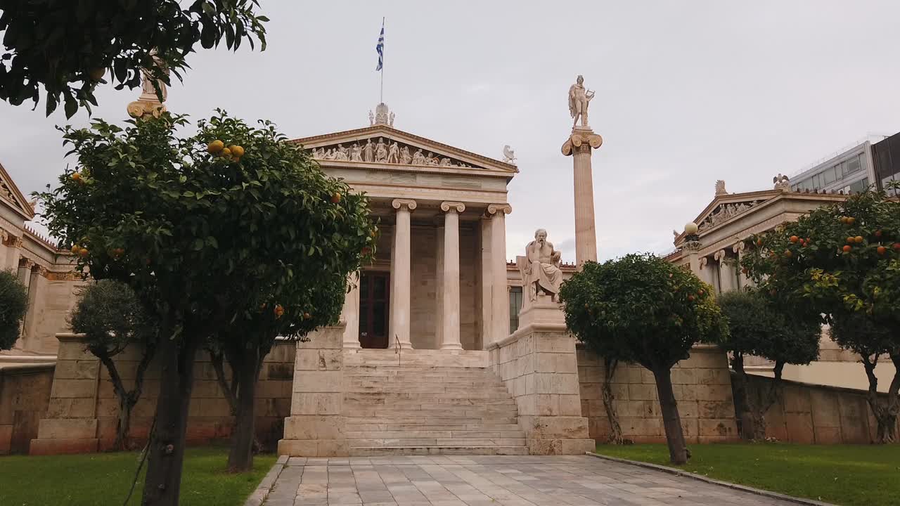 Sidewards dolly shot, orange trees revealing, academy of Athens Greece.