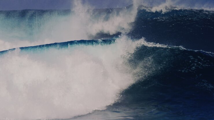 Stunning set waves crash and explode with whitewash and mist rising off top in slow motion, Cloudbreak Fiji