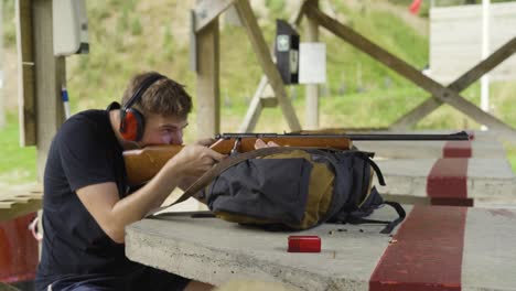 portrait of a man aiming a target in rifle shooting range