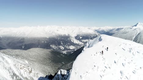 skiers walking on a snow capped mountain 4k