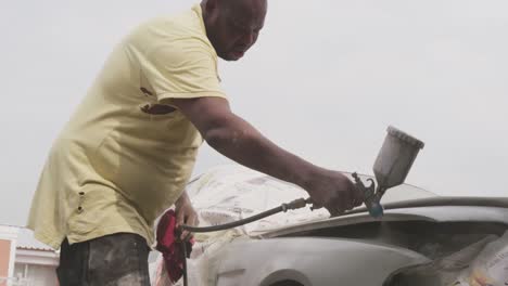 african man repairing car