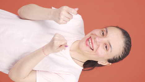 vertical video of woman making money sign with her hands.